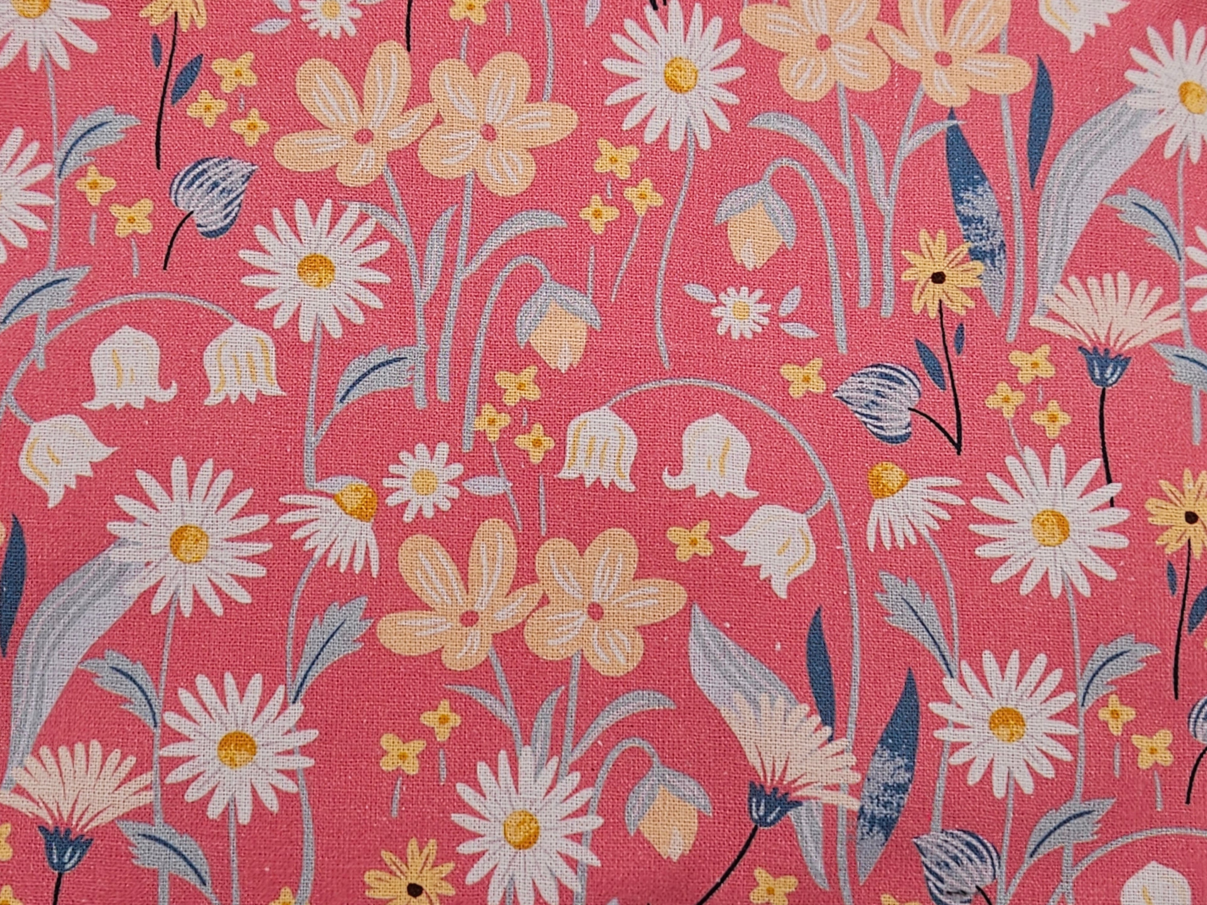 Floral pattern with daisies and other flowers on a pink background