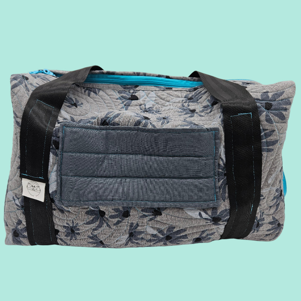 Floral-patterned duffel bag with a gray pocket