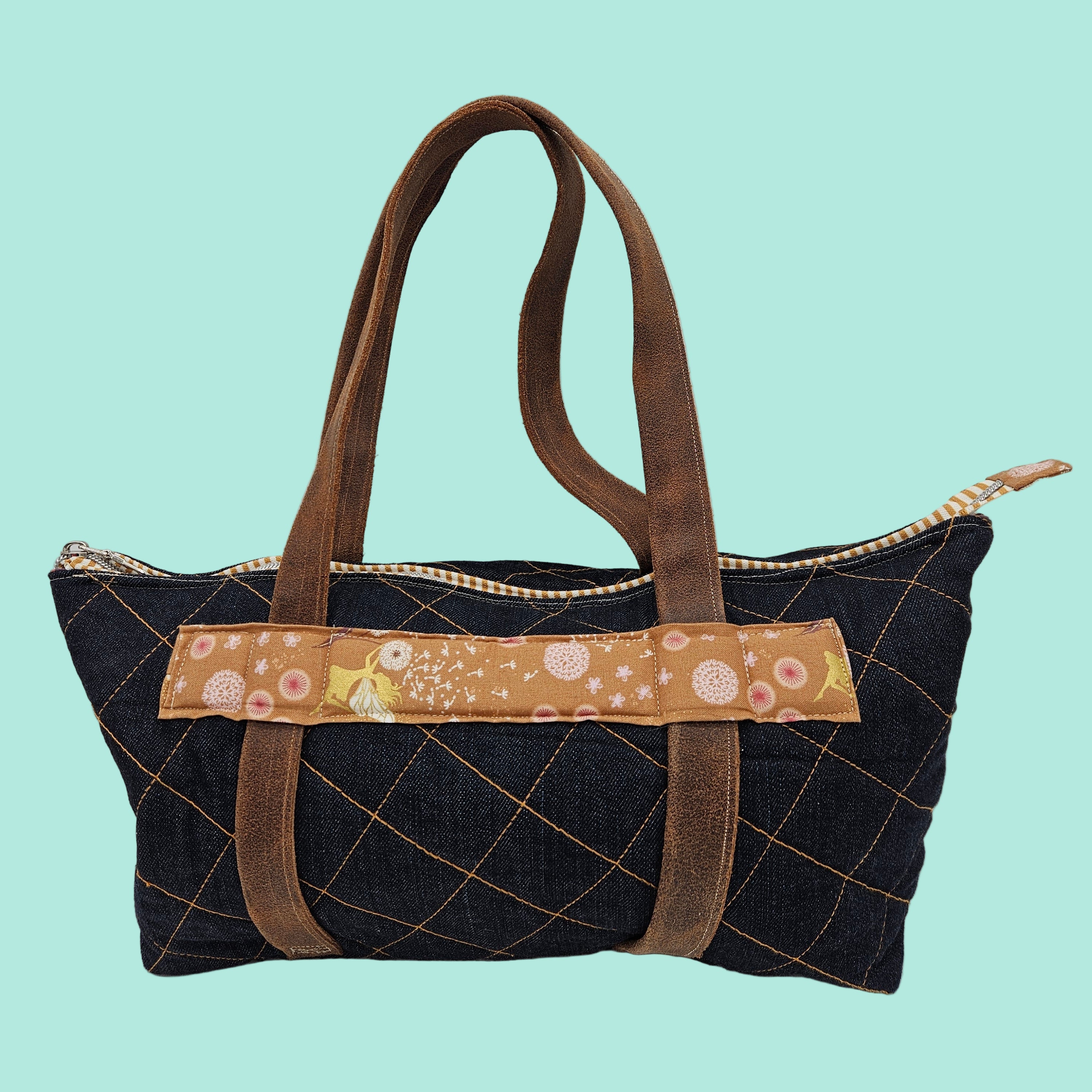 Handbag with a decorative strap on a light gray background