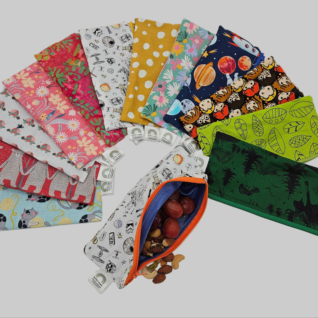 Collection of colorful fabric pouches with various patterns on a white background