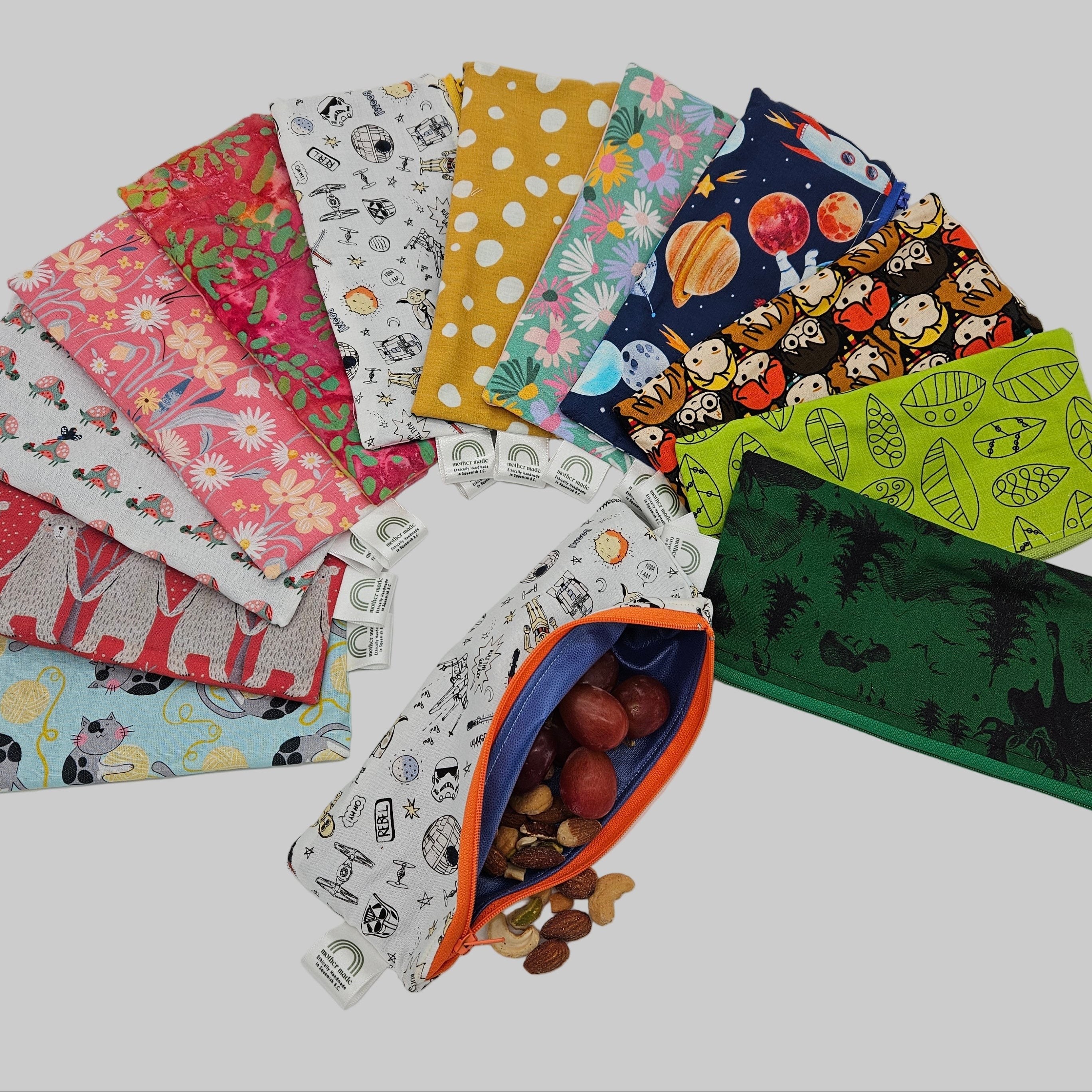 Collection of colorful fabric pouches with various patterns on a white background