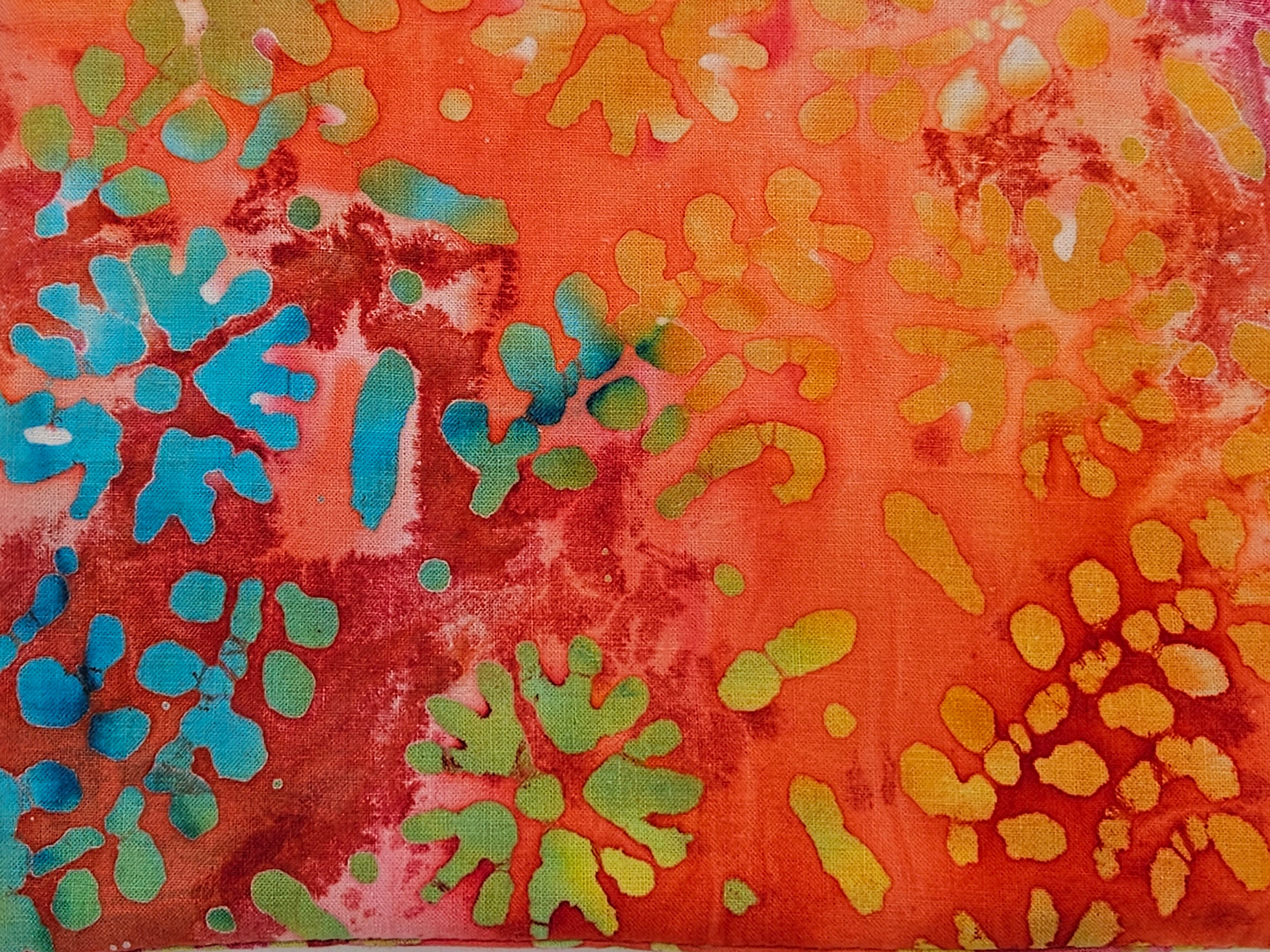 Abstract pattern with blue, green, and yellow colors on a red background