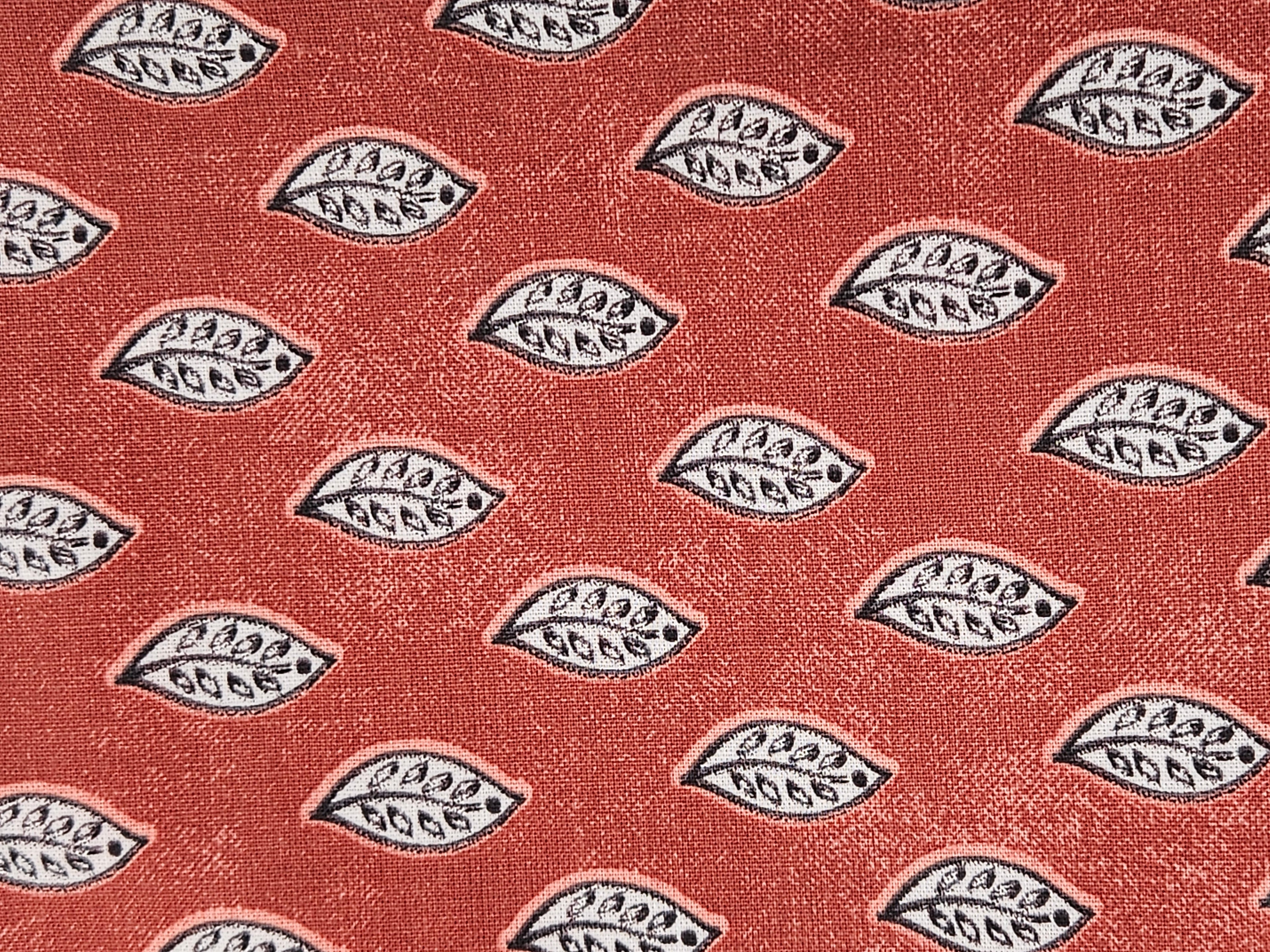 Pattern of a  leaf design on a red-brown background