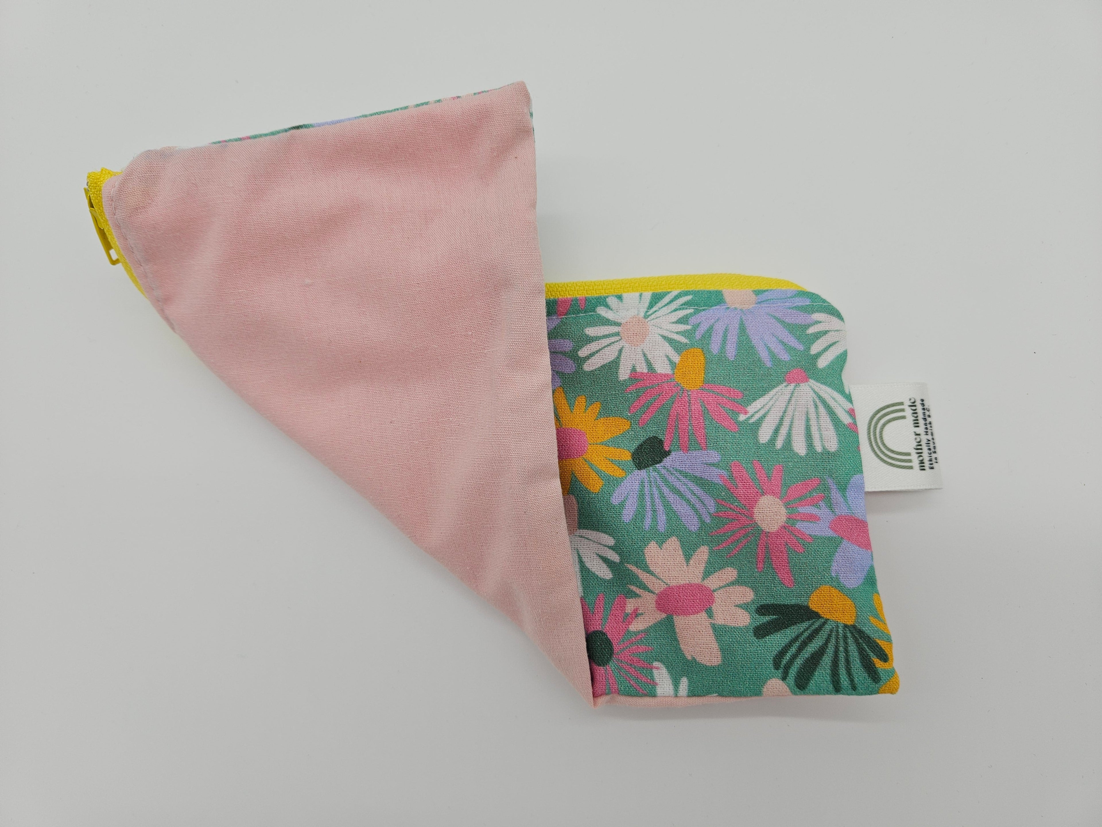 Two sided, one pink and one with floral pattern, on a light gray background.