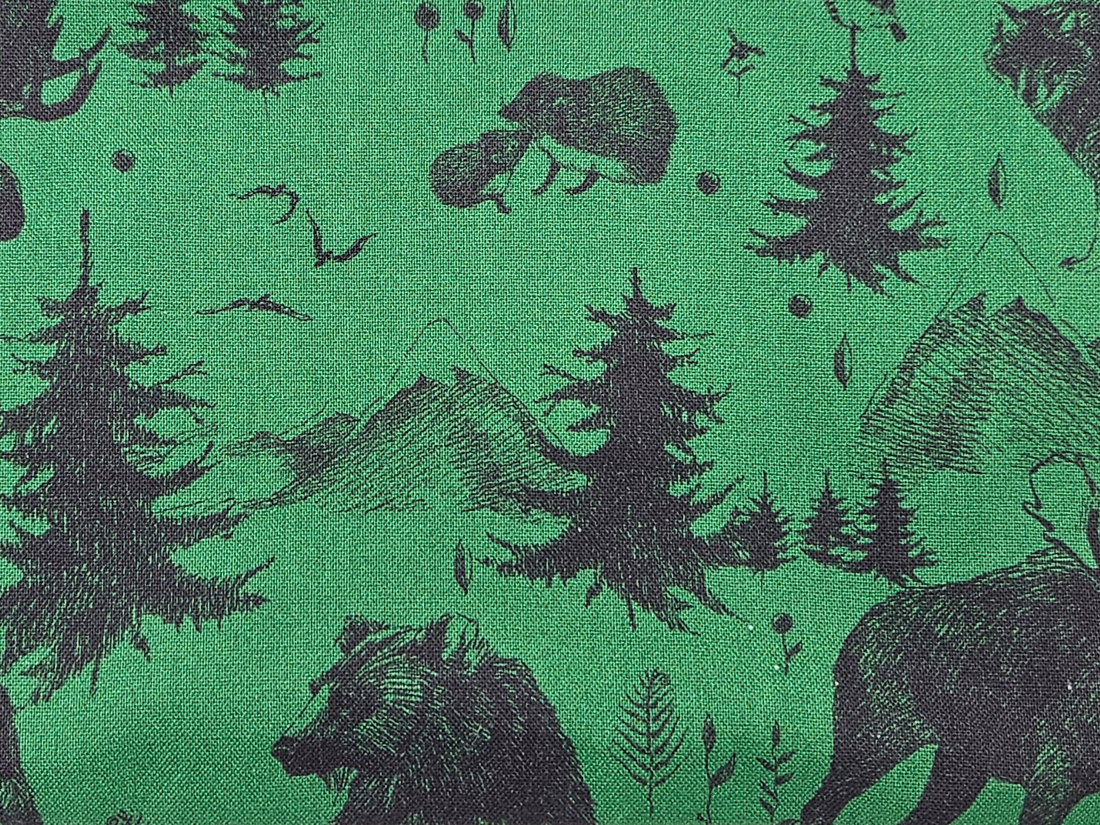Fabric with black bear and mountain pattern on green background