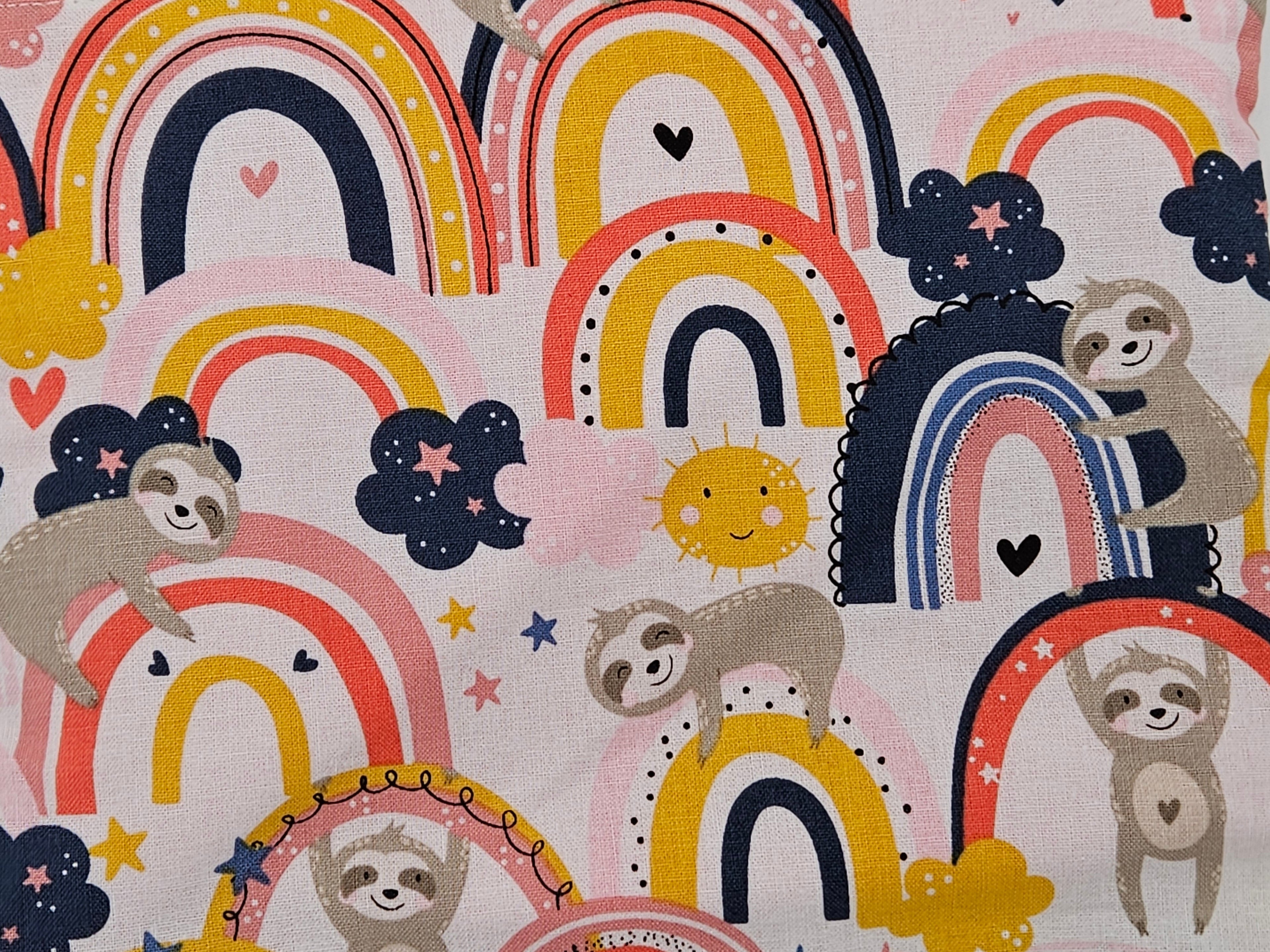 Pattern of sloths, rainbows, and clouds on a light background