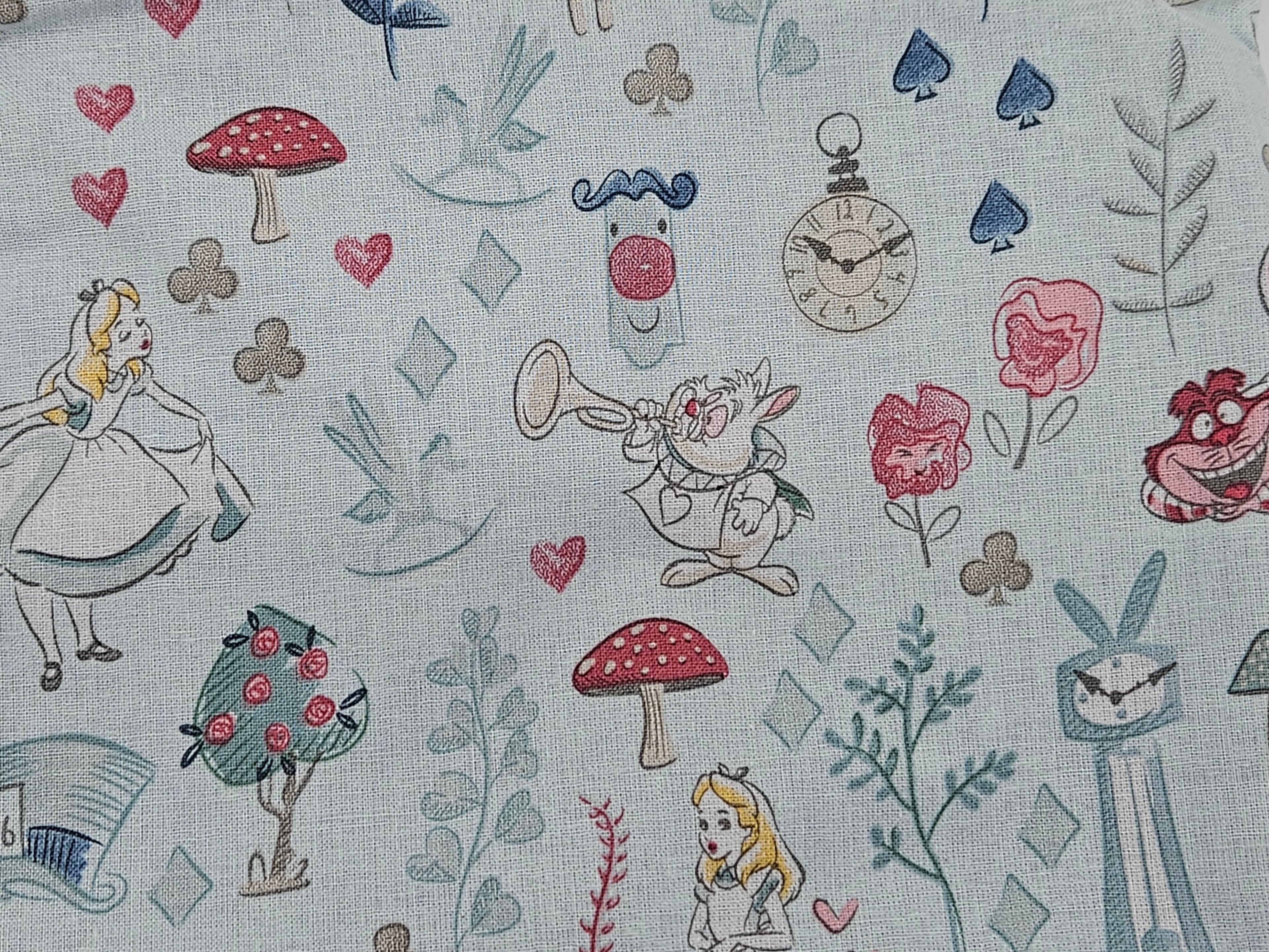 Pattern of Alice in Wonderland characters and elements like mushrooms, hearts, and flowers on a light blue background.
