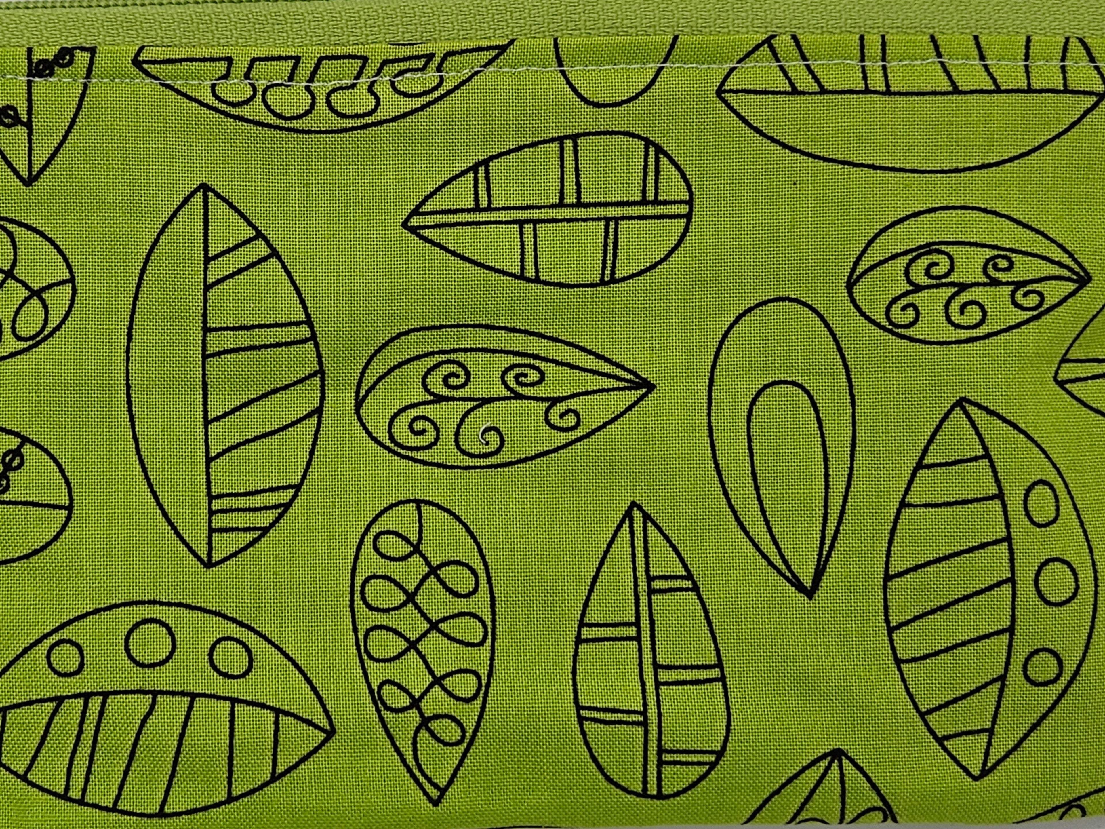 Pattern of leaf shapes on a green background